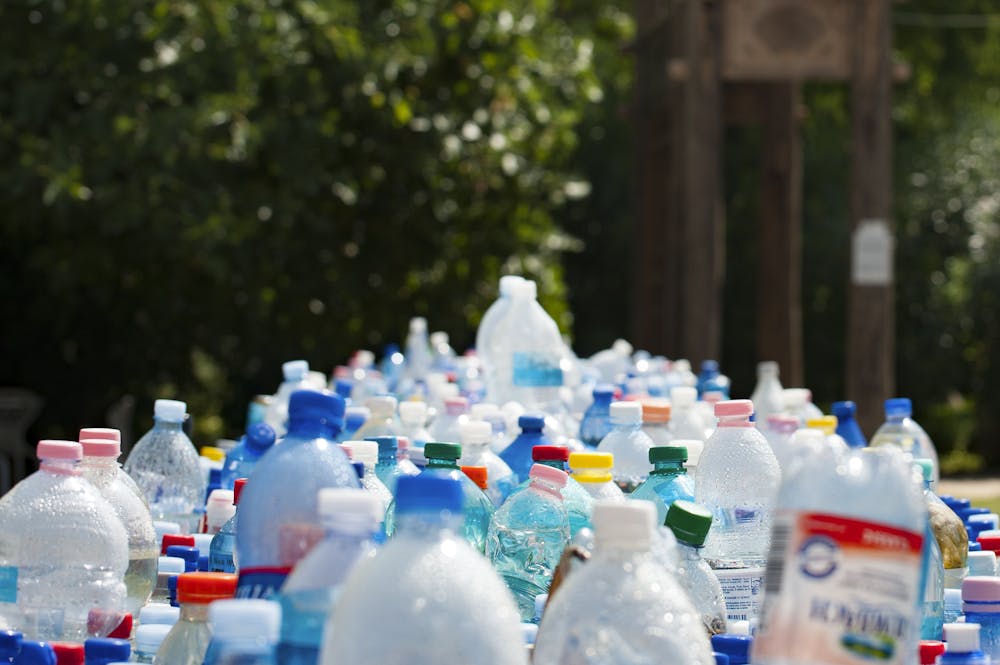 A vibrant collection of plastic bottles in an outdoor recycling setup, showcasing environmental awareness.