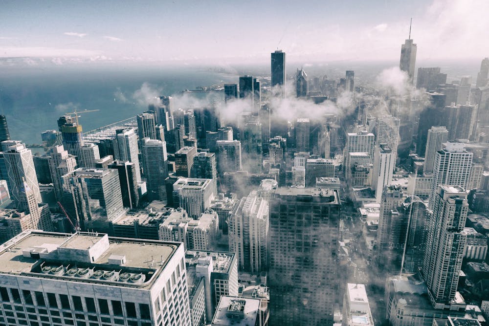 Stunning aerial perspective of Chicago's skyline with clouds, showcasing urban architecture.