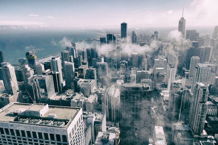 Stunning aerial perspective of Chicago's skyline with clouds, showcasing urban architecture.