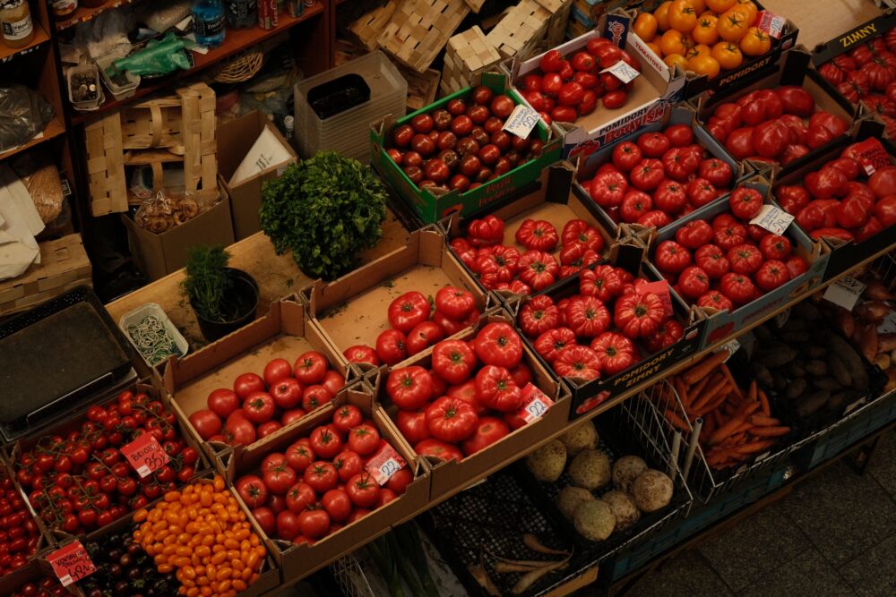Aerial view of vibrant tomatoes and vegetables at an indoor market in Breslau, Poland.