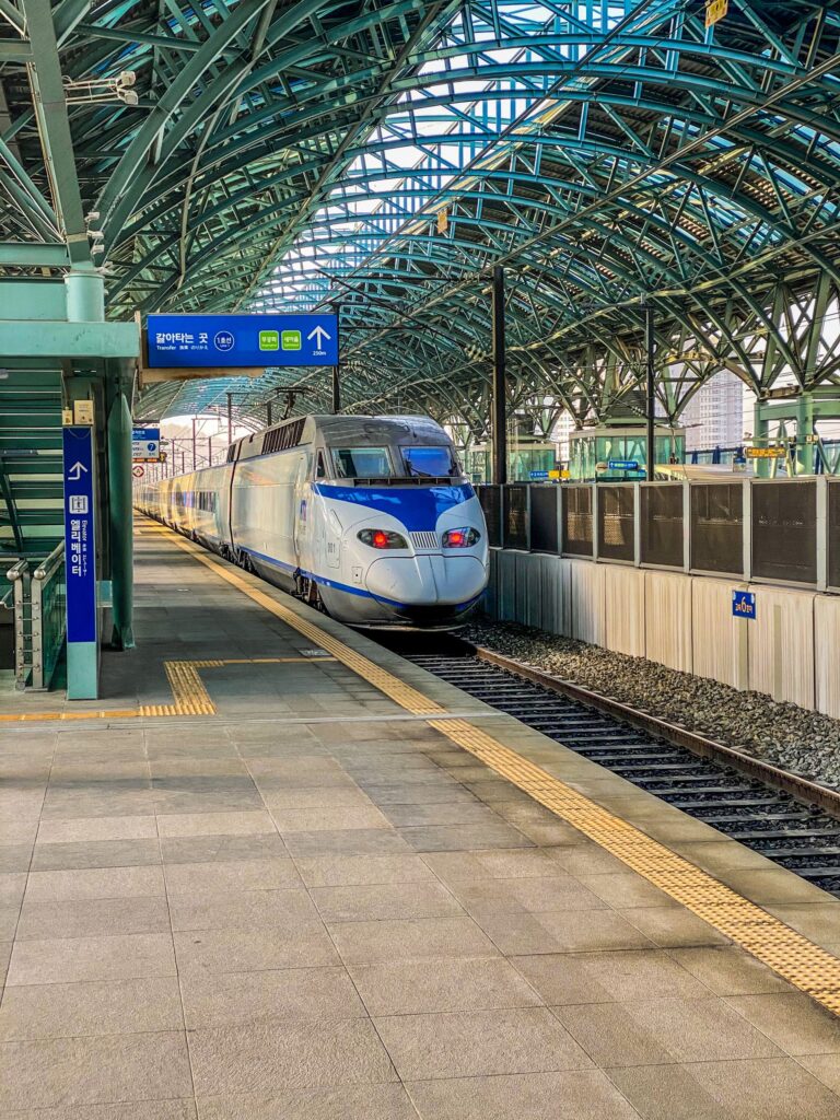 High-speed train arriving at Asan station on a bright day in South Korea, showcasing modern rail travel.