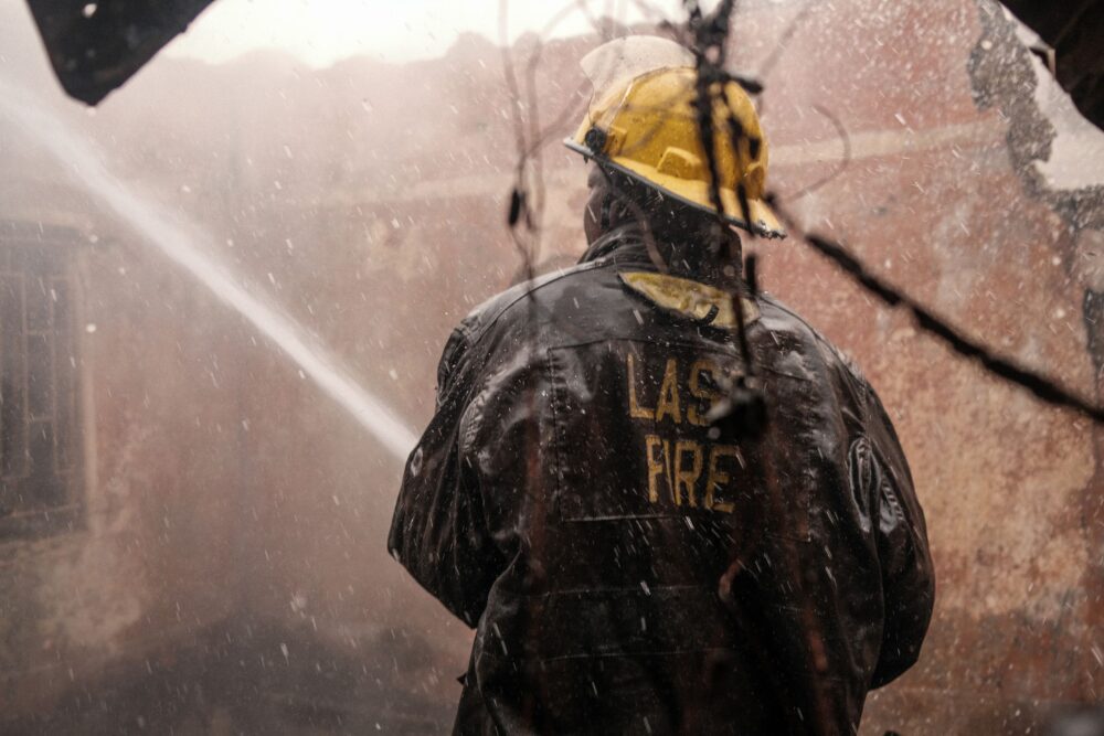Lagos firefighter in action during challenging emergency conditions.